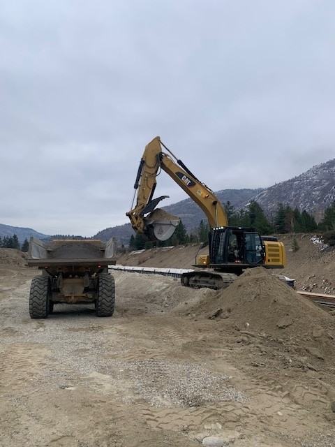 Excavator loading a dump truck